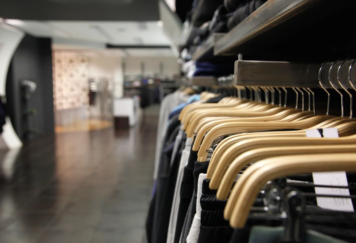 Wooden clothing hangers on retail rack